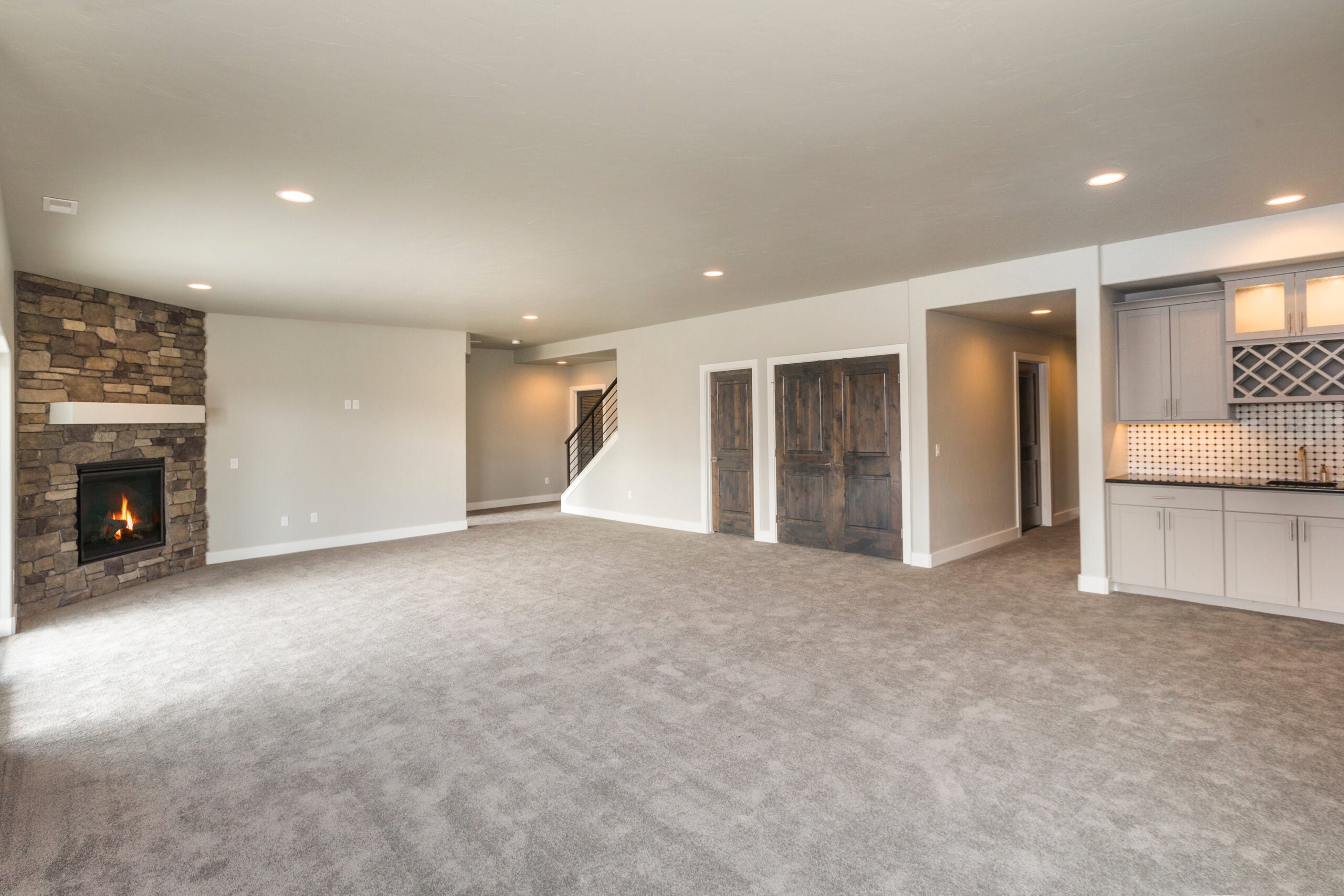 Finished basement with carpet, wet bar and brick fireplace