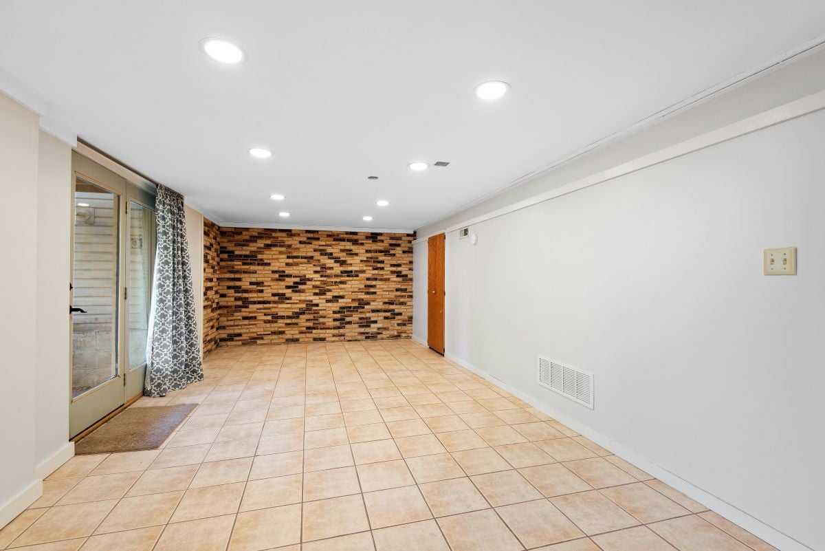 Finished basement with tile flooring 