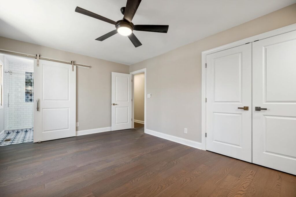 Finished basement bedroom with bright tile bathroom