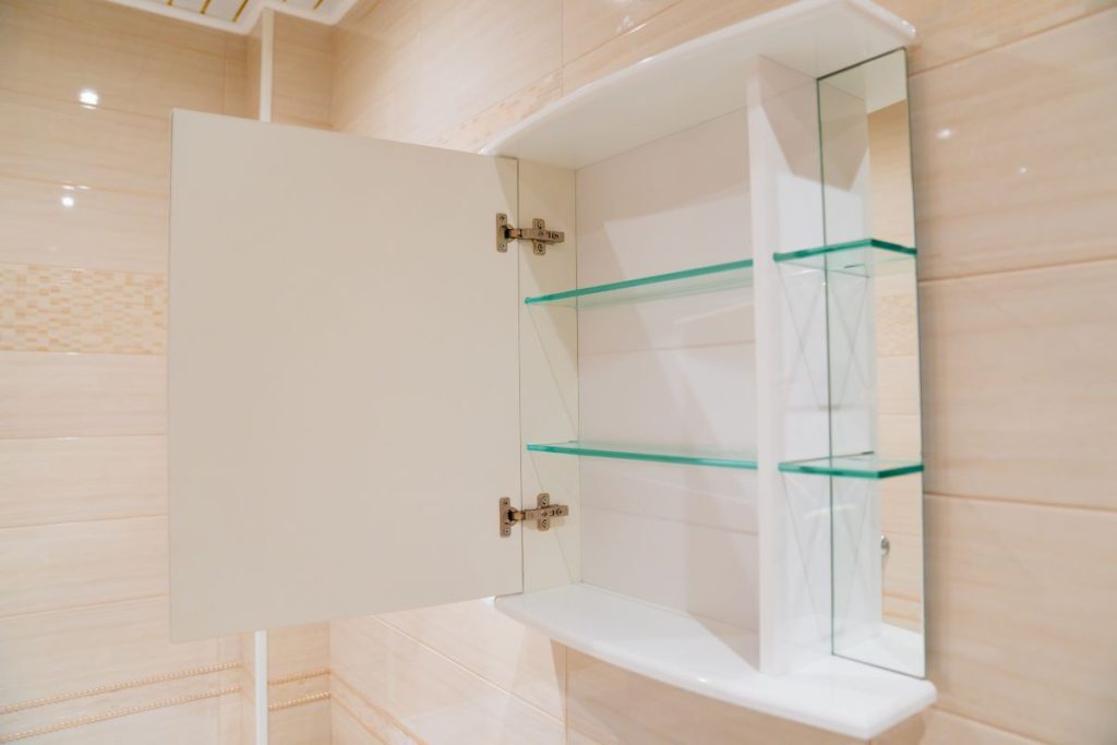 bathroom with mirrored cabinet for storage