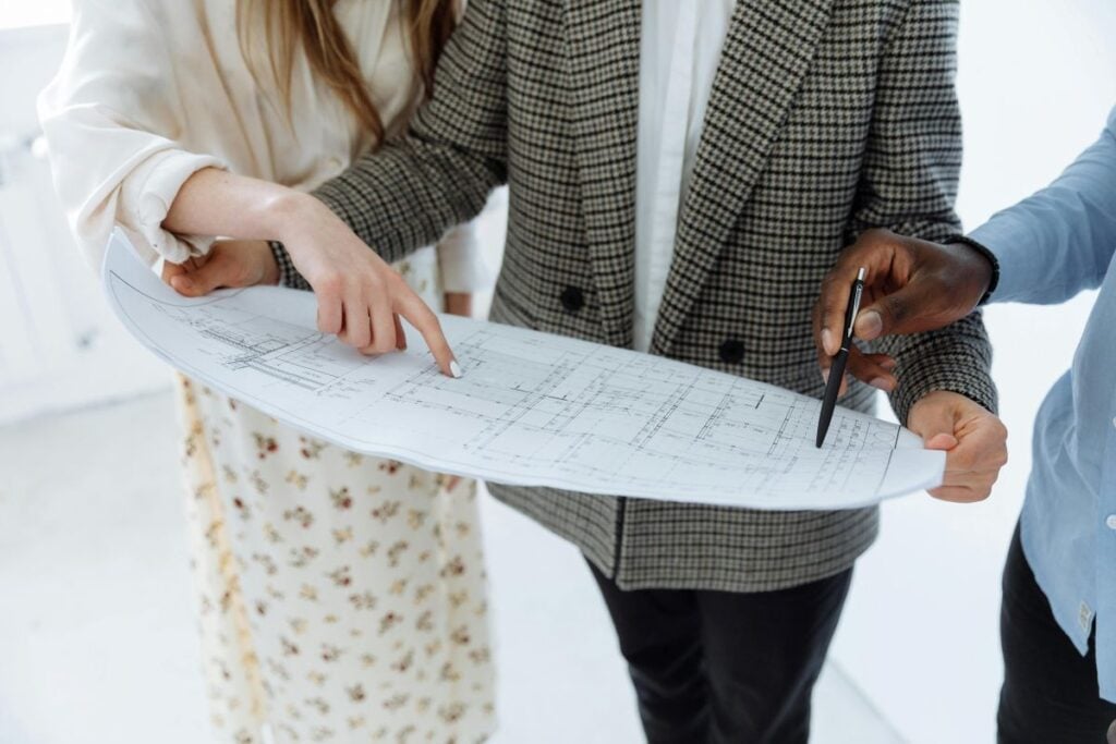 People reviewing construction floor plan