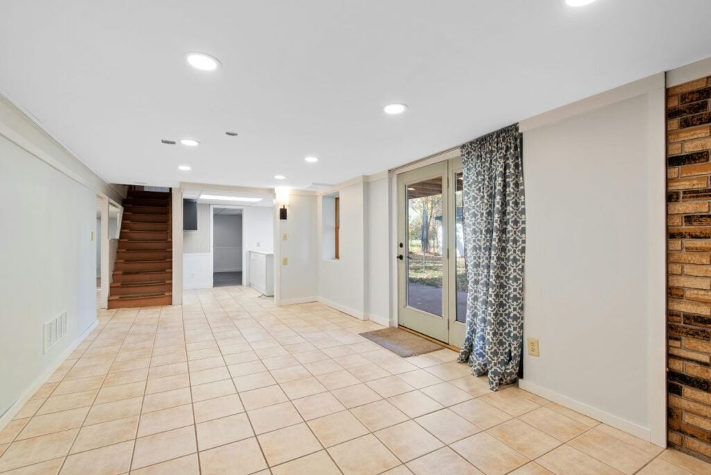 A clean, open basement room ready for remodeling
