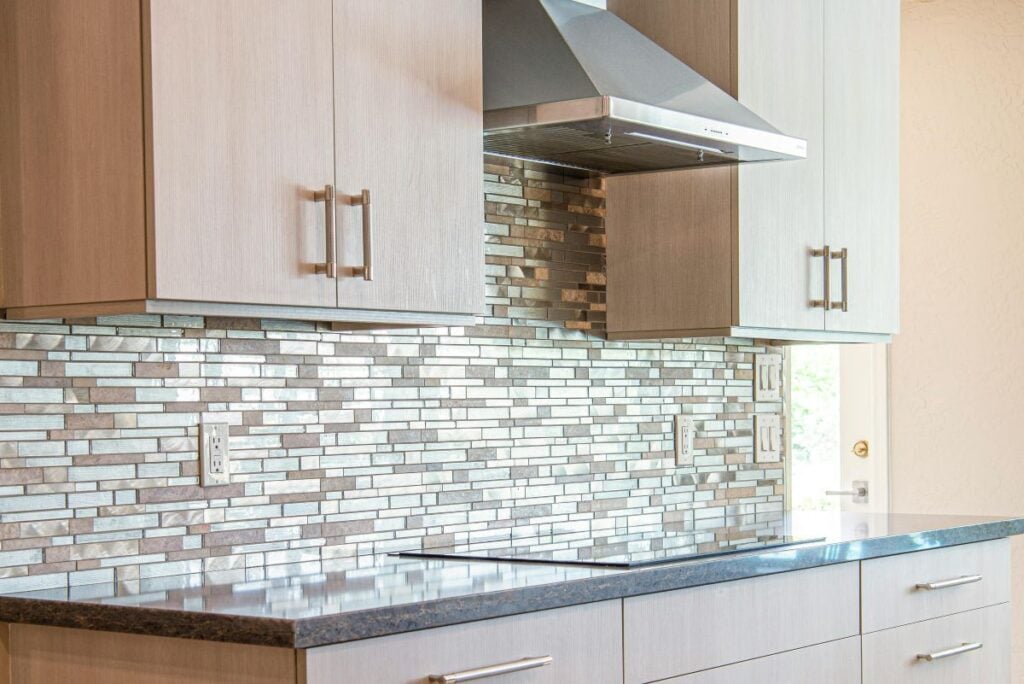 Remodeled kitchen with mosaic backsplash