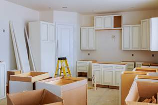 Kitchen cabinets and countertops being installed during a remodel