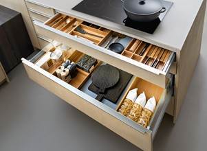 Kitchen drawer storage with organized inserts for utensils, cookware, and pantry items
