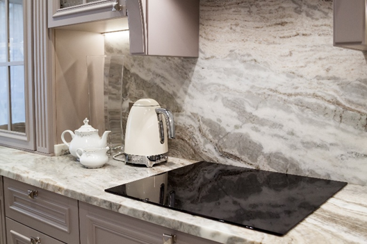Kitchen countertop with marble surfaces and induction cooktop