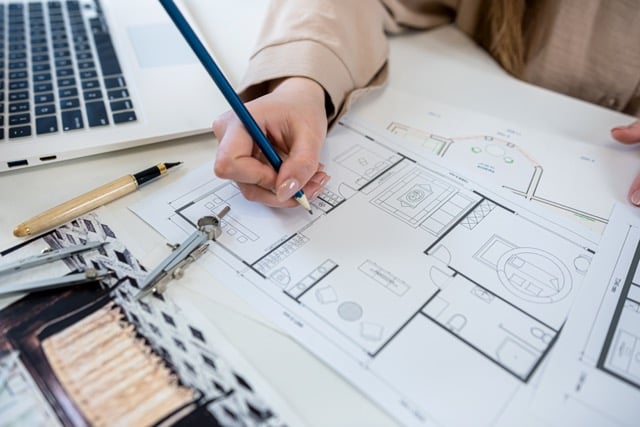 young woman working on basement architect blueprint for a remodel project