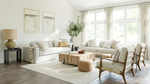 Bright remodeled living room with large windows, neutral furnishings, and hardwood floors.