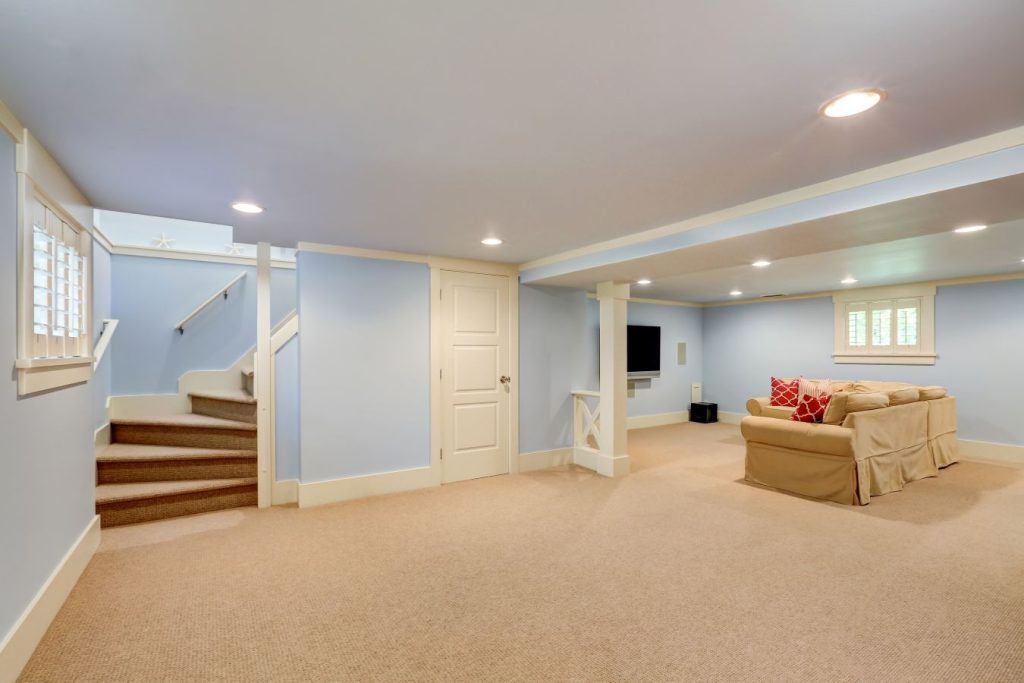 Spacious finished basement with light blue walls