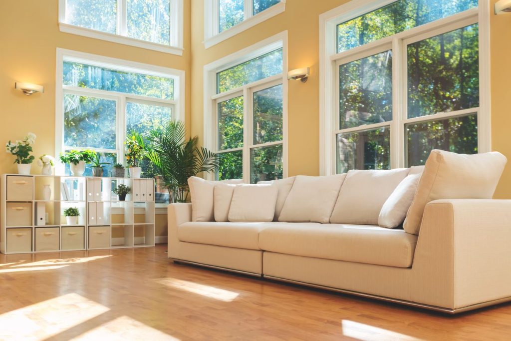 Refreshed living room featuring yellow-painted walls and white-trimmed windows