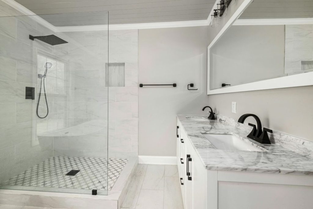 modern newly remodeled bathroom with quartz countertop and matte black finishes