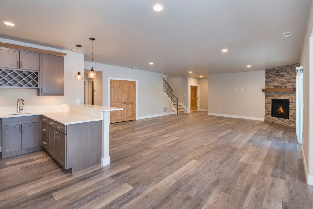 Spacious finished basement with brick fireplace and wet bar