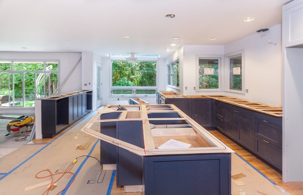 dark colored cabinets being installed during kitchen remodeling project