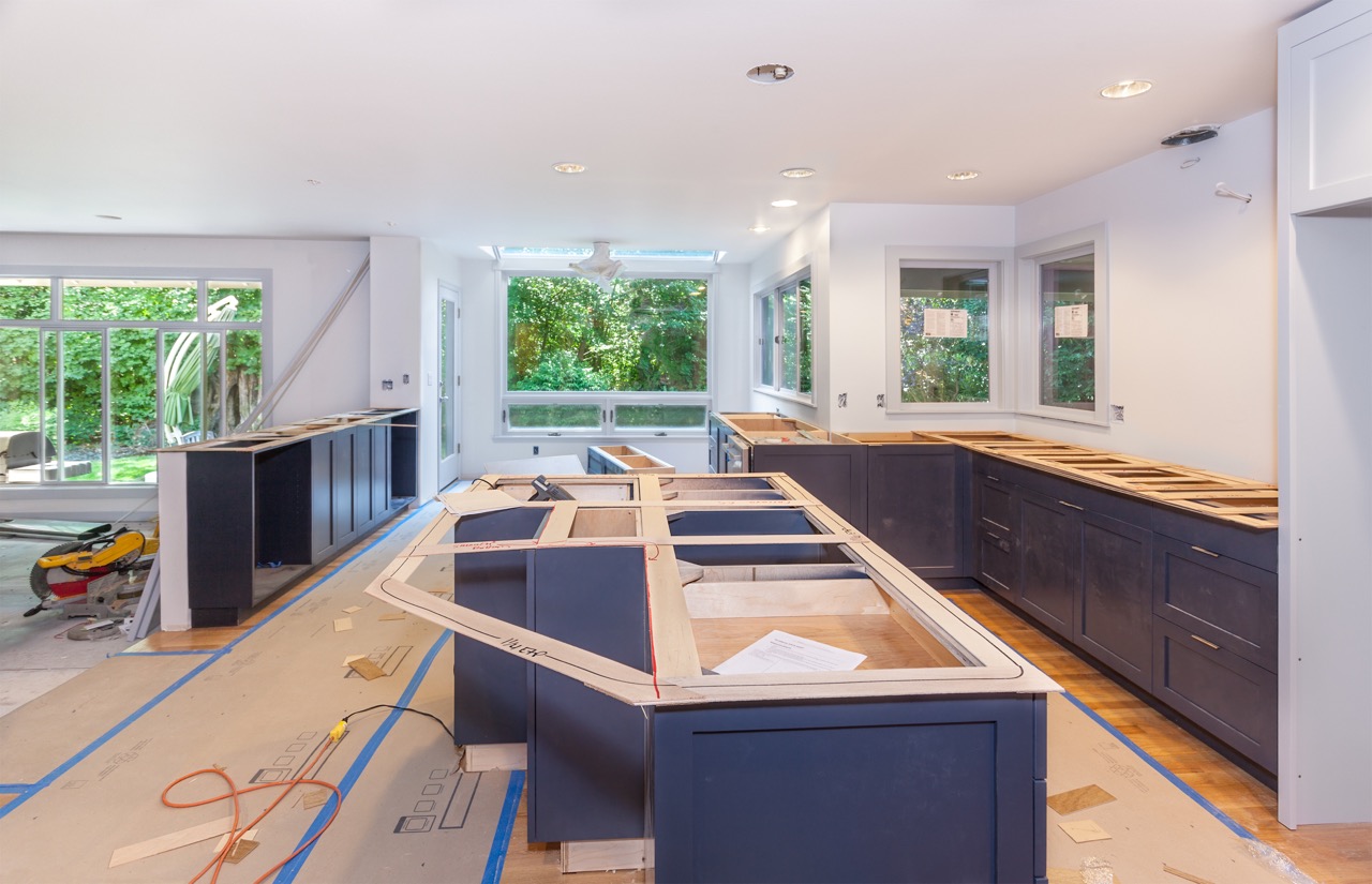 dark colored cabinets being installed during kitchen remodeling project