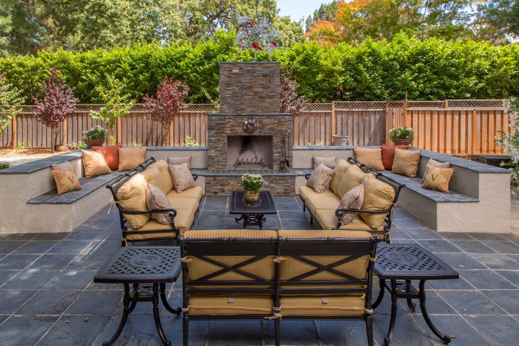 spacious outdoor seating area with brick fireplace