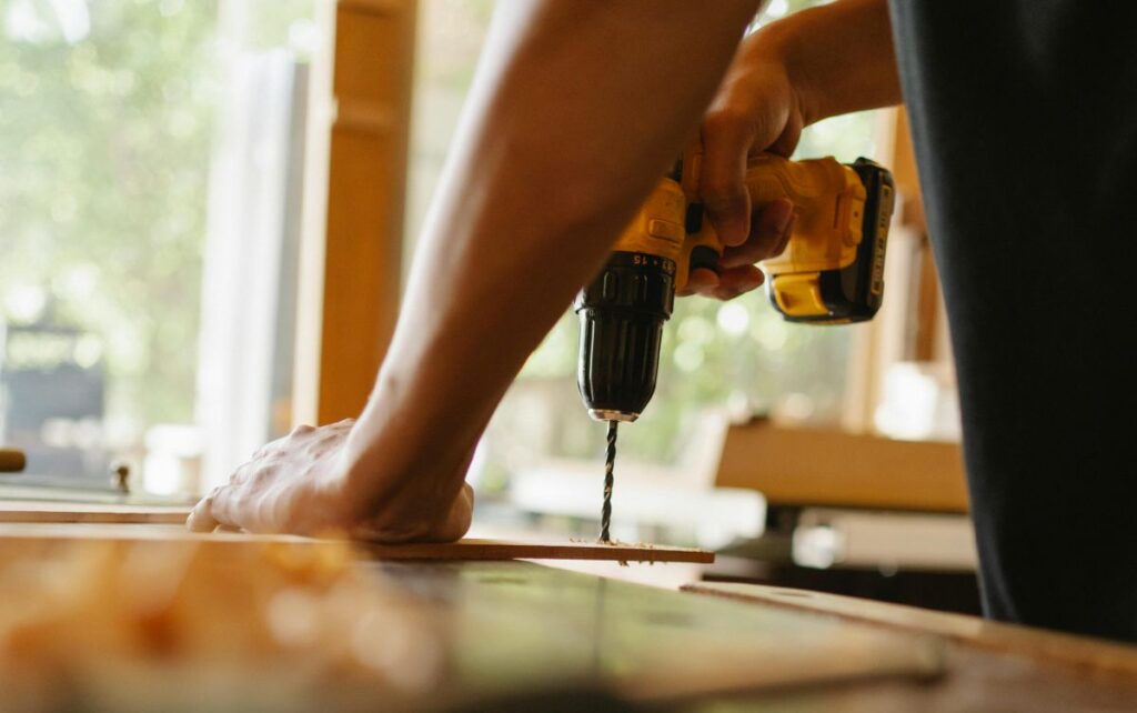 person using a cordless drill for remodeling work