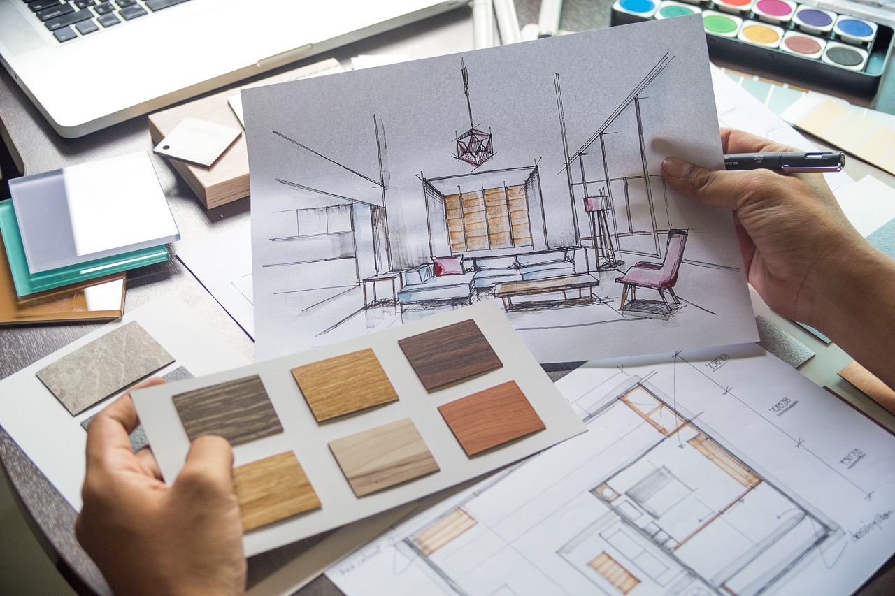 professional designer holding home remodel design plans and materials samples
