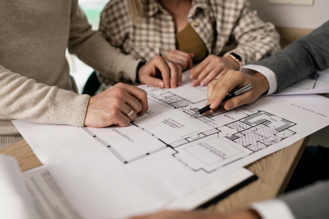 Clients reviewing remodeling floorplan with contractor