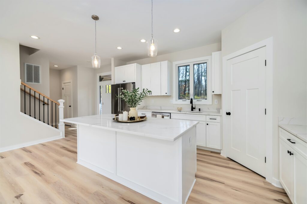 Bright remodeled kitchen with white cabinetry and quartz countertops