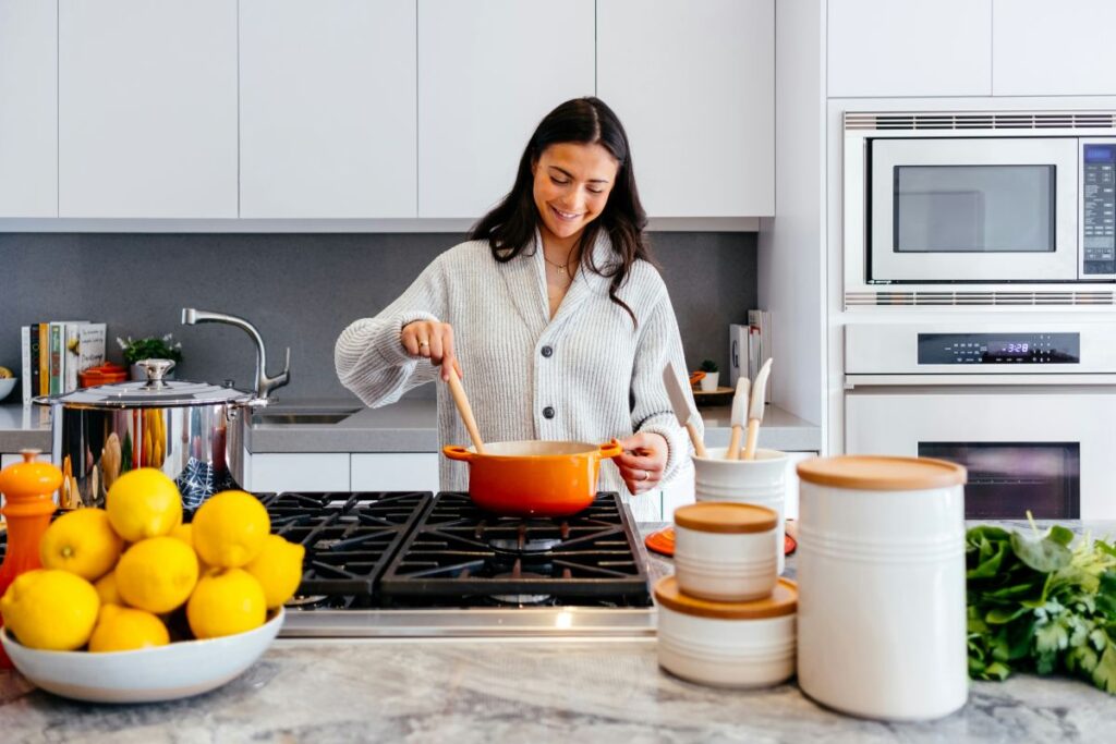 Woman cooking in newly remodeled kitchen