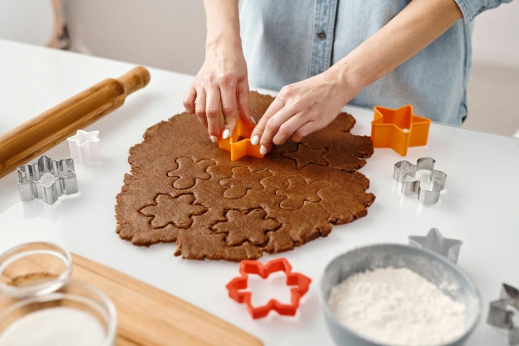 Baking gingerbread cookies in kitchen