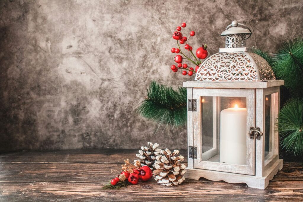 Decorative holiday lantern with candle and decor