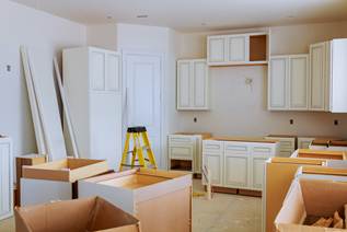 Kitchen cabinets and countertops being installed during a remodel