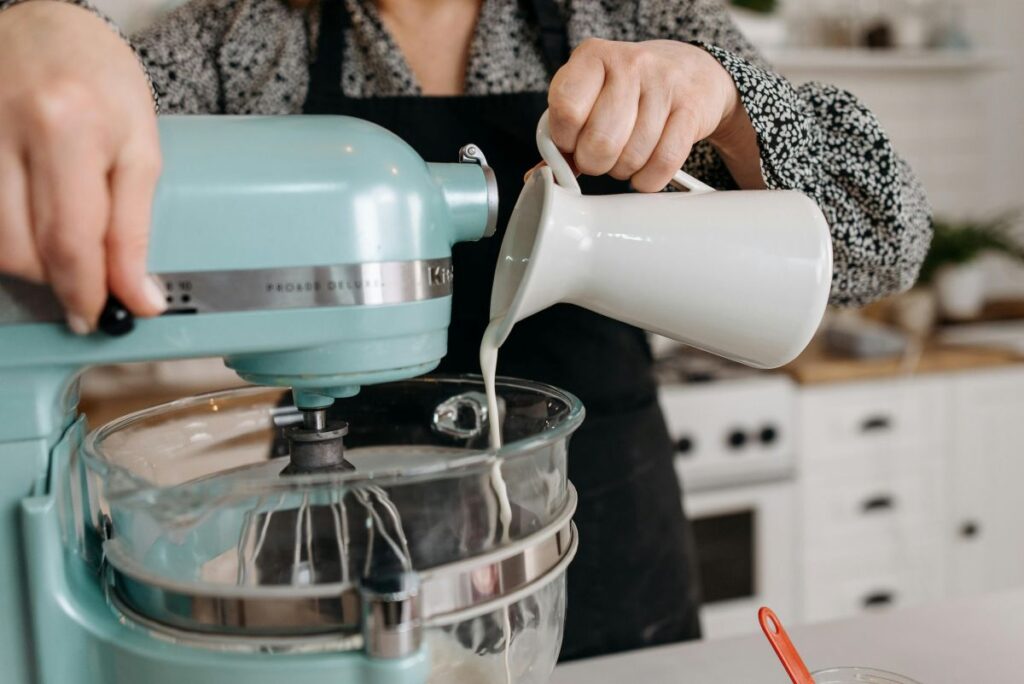 Person baking with a stand mixer in a kitchen