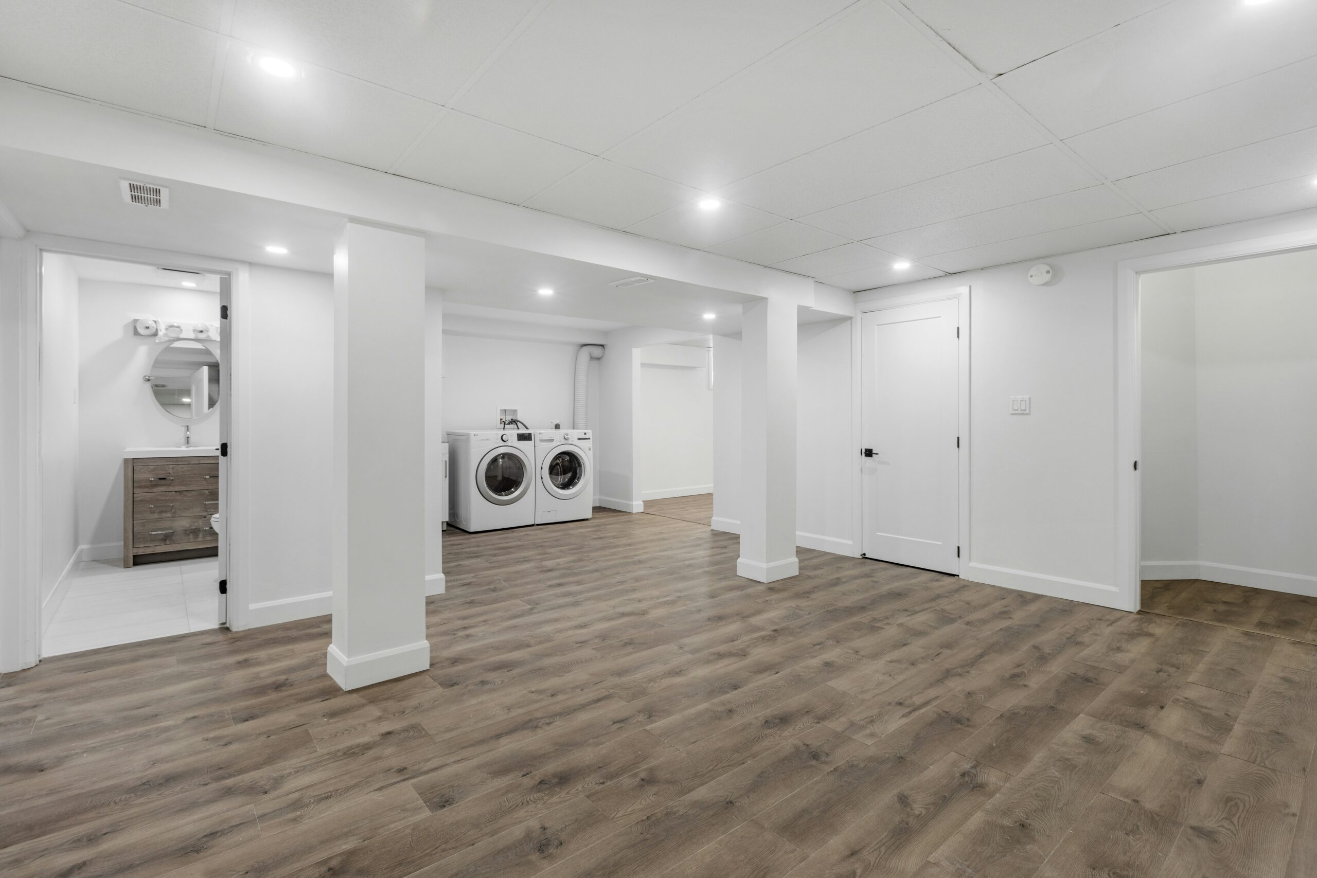 Bright finished basement with laundry area and bathroom