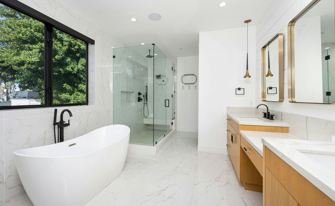 Bright primary bathroom with large soaking tub and separate glass shower